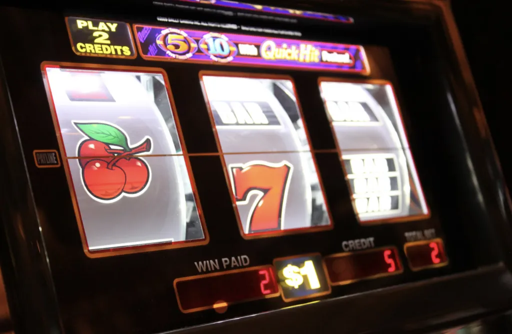 Classic slot machine with cherries and a seven on the screen